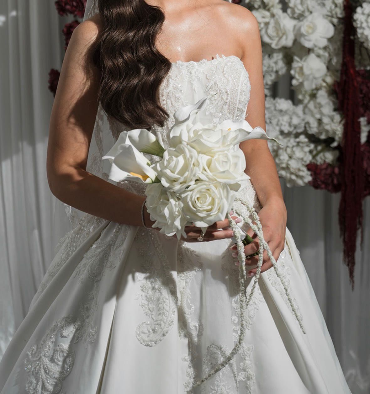 Bride holding the Maya bouquet of artificial white roses and calla lilies