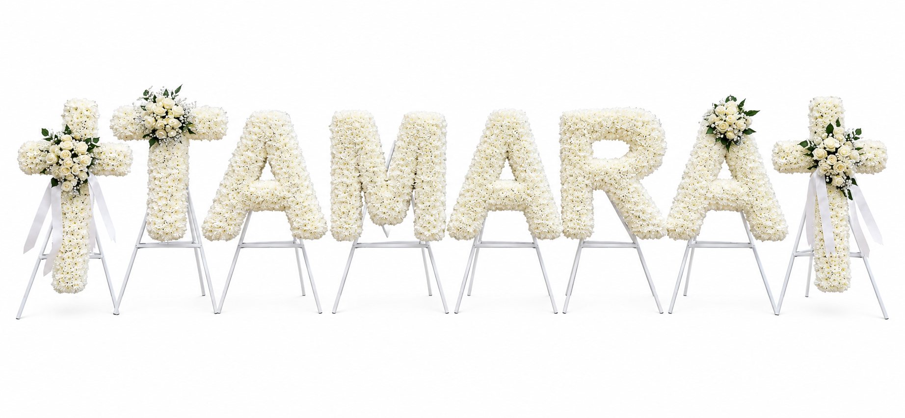 White chrysanthemum letter tribute spelling a name, with rose sprays