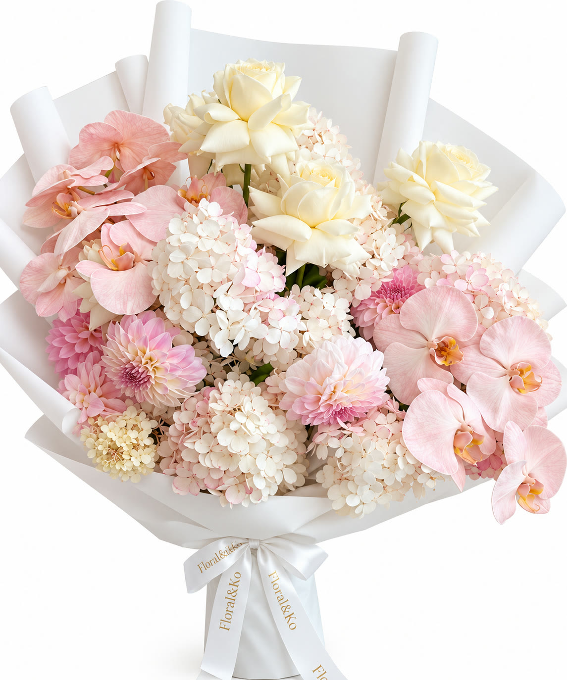 Luxe bouquet of pink orchids, cream roses, dahlias and hydrangea in white wrap