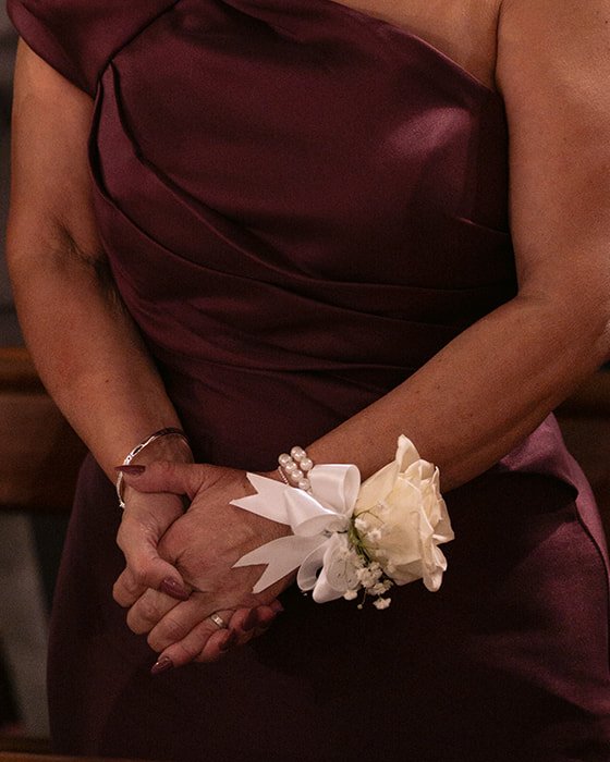 White rose and baby's breath wrist corsage with pearl band